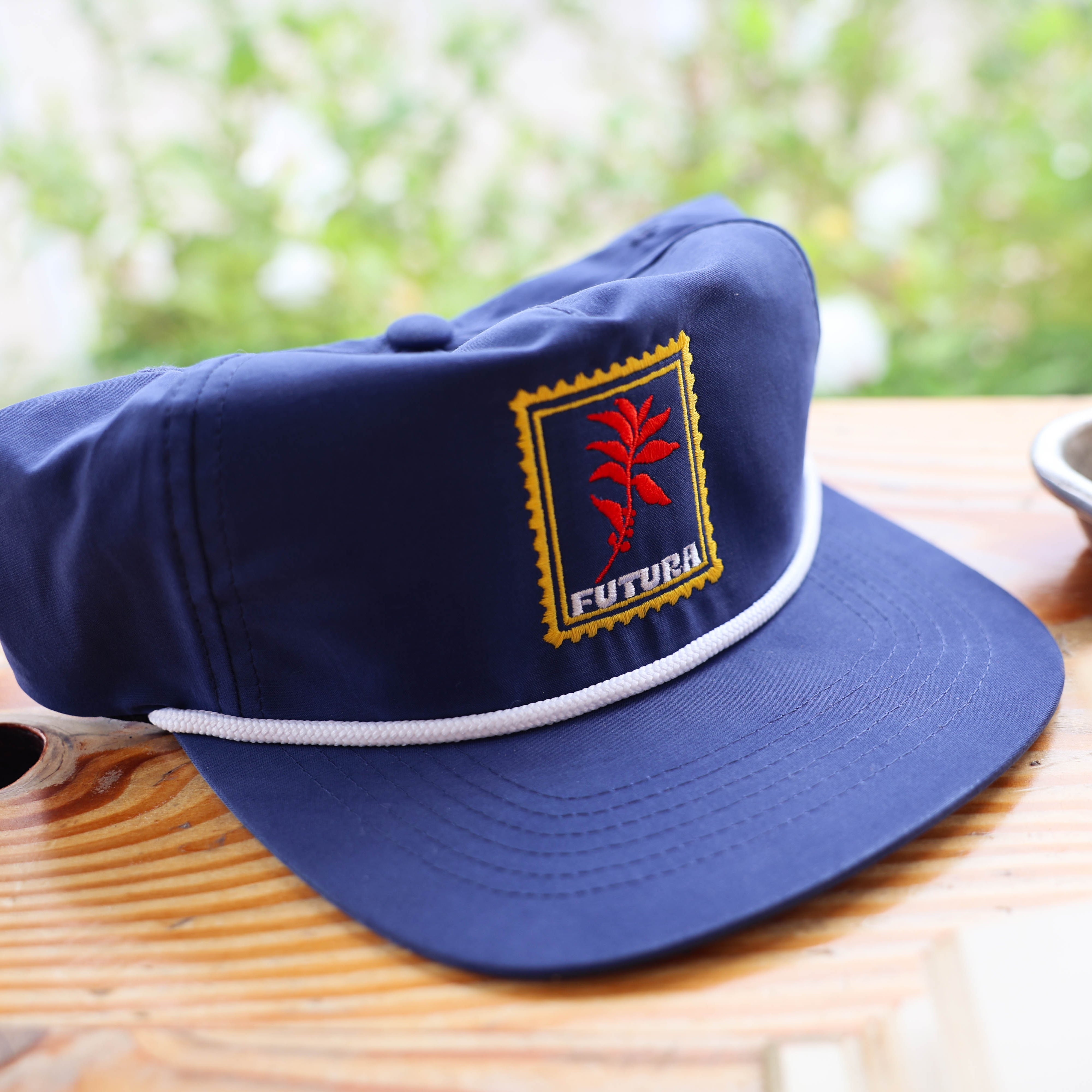 Futura cap with a logo on a wooden surface